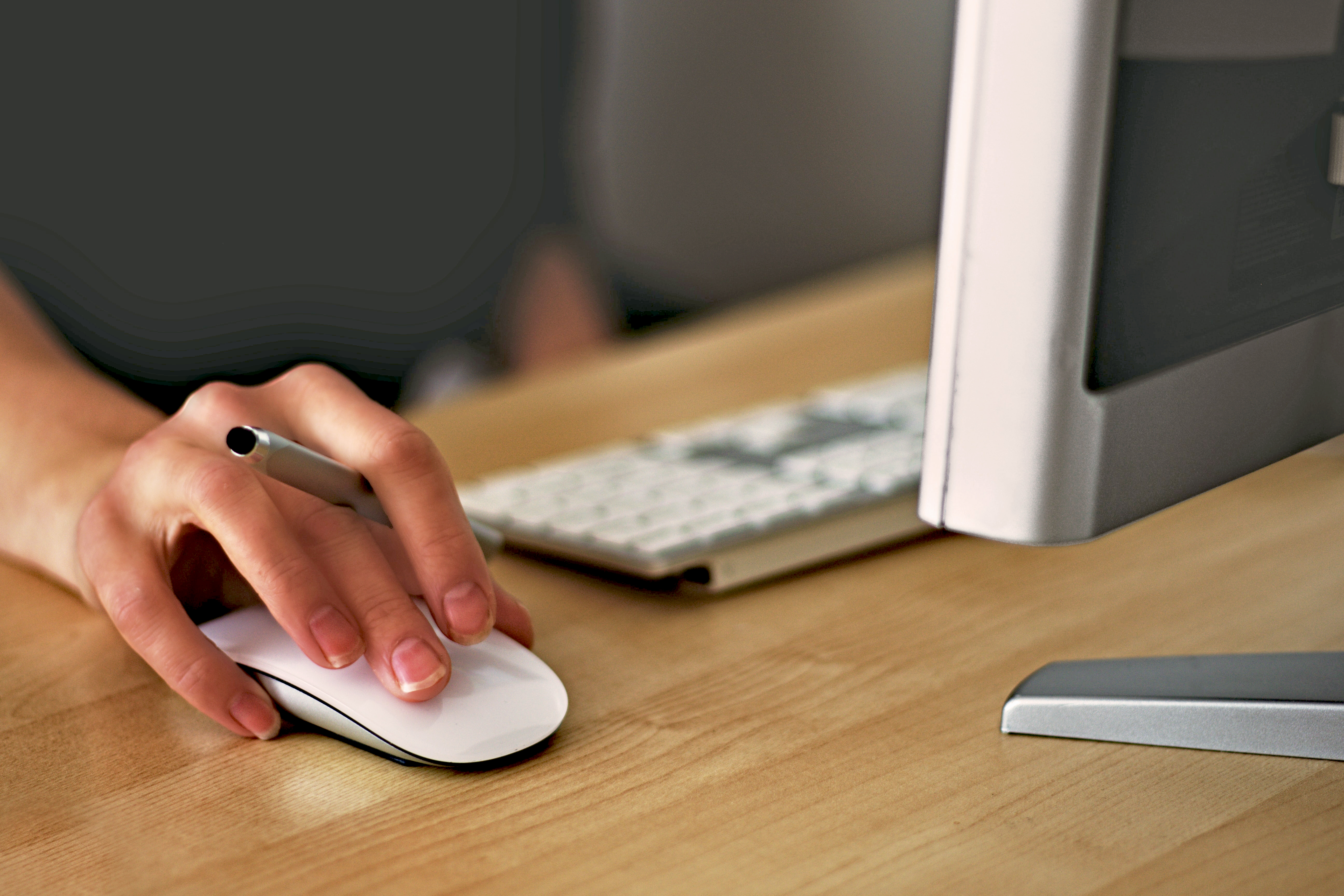 A Person Using A Computer Mouse And Keyboard